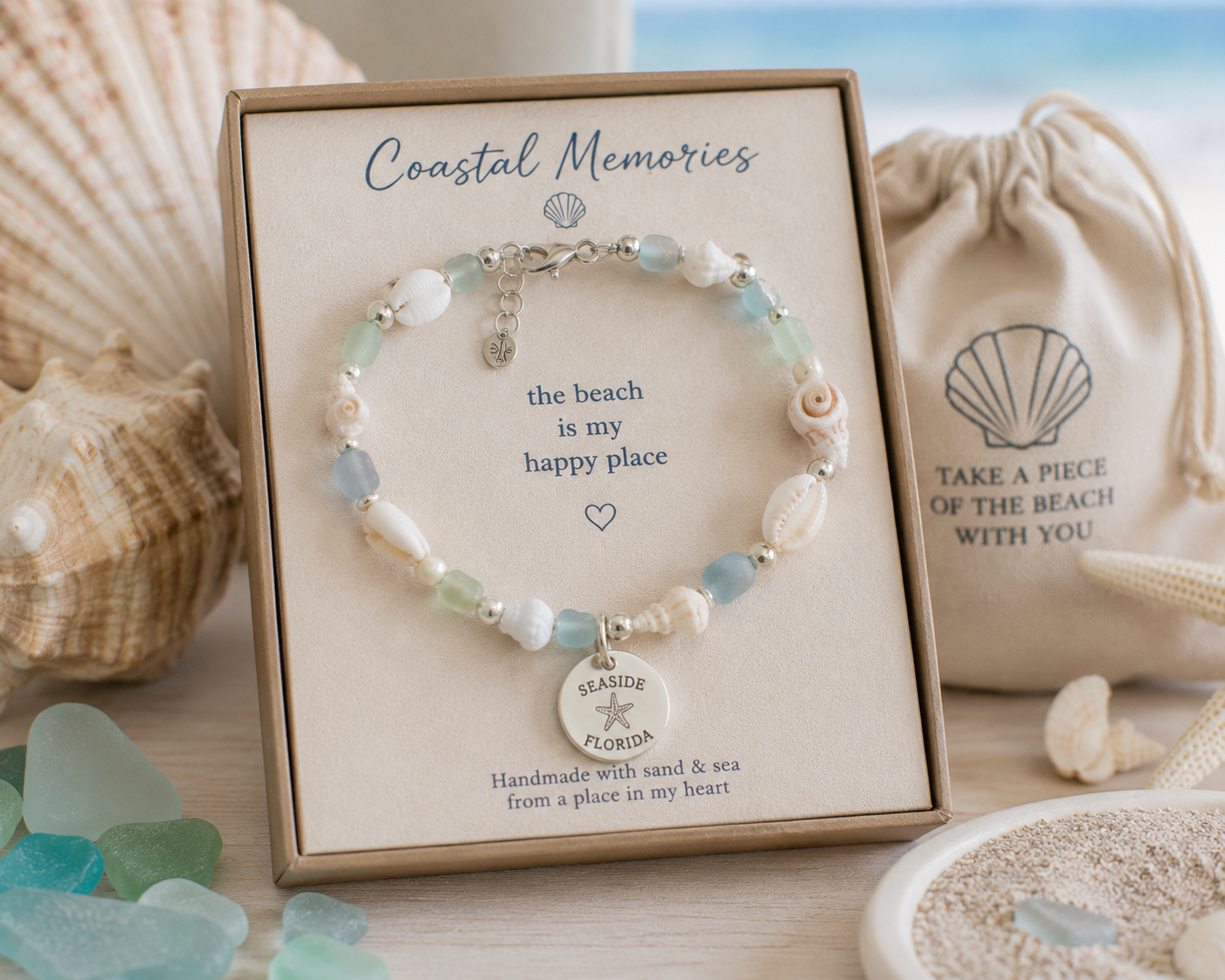 Shell charm bracelet styled in a coastal keepsake box with sea glass and shells